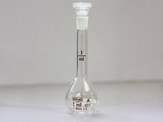 Small glass volumetric flask with measurement marking. 