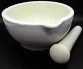 White mortar and pestle on a black background